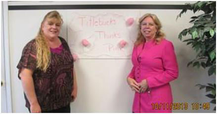 two women standing in front of a poster