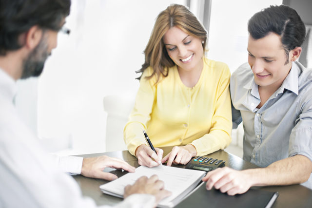 people signing a document